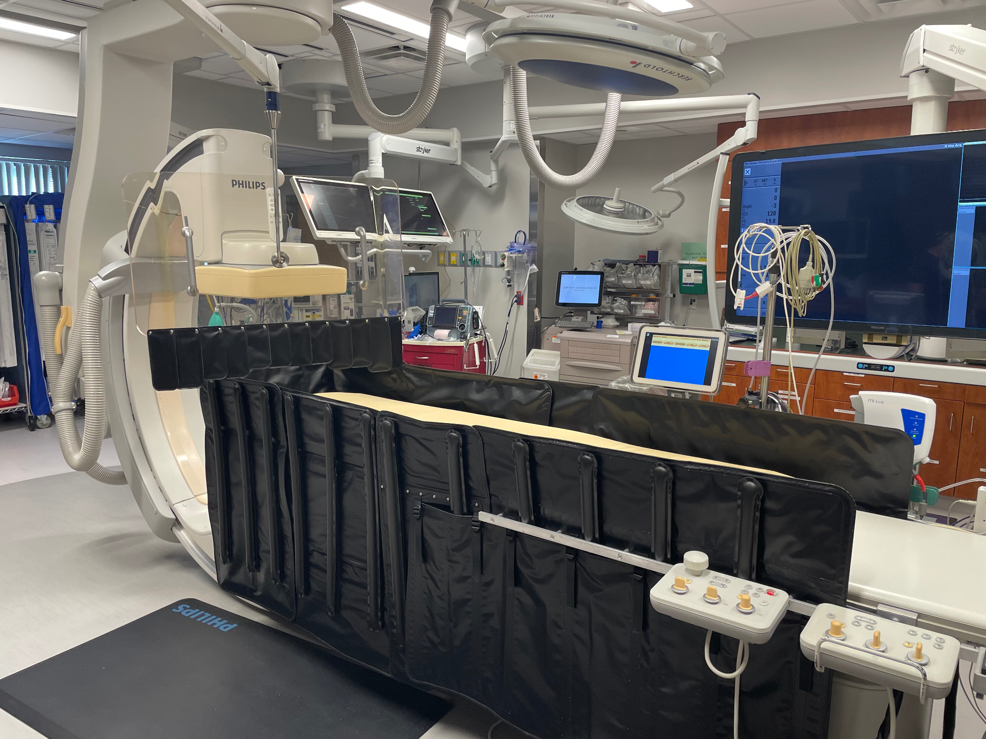 AeroShield system deployed on a Philips cath lab table with the inflatable lower shield and OptiShield upper barrier in place